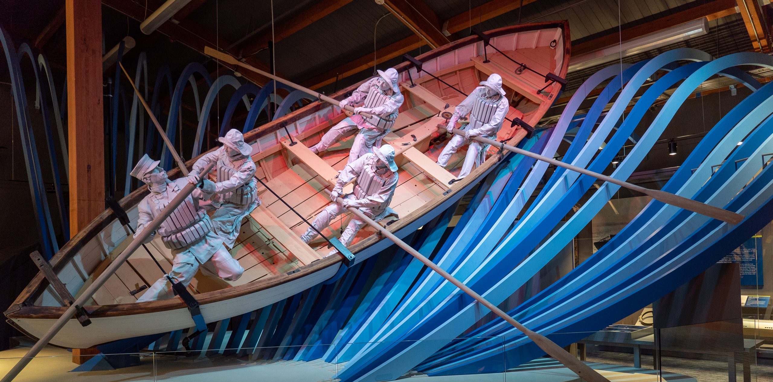 display of a surfboat with mannequins depicting life savers