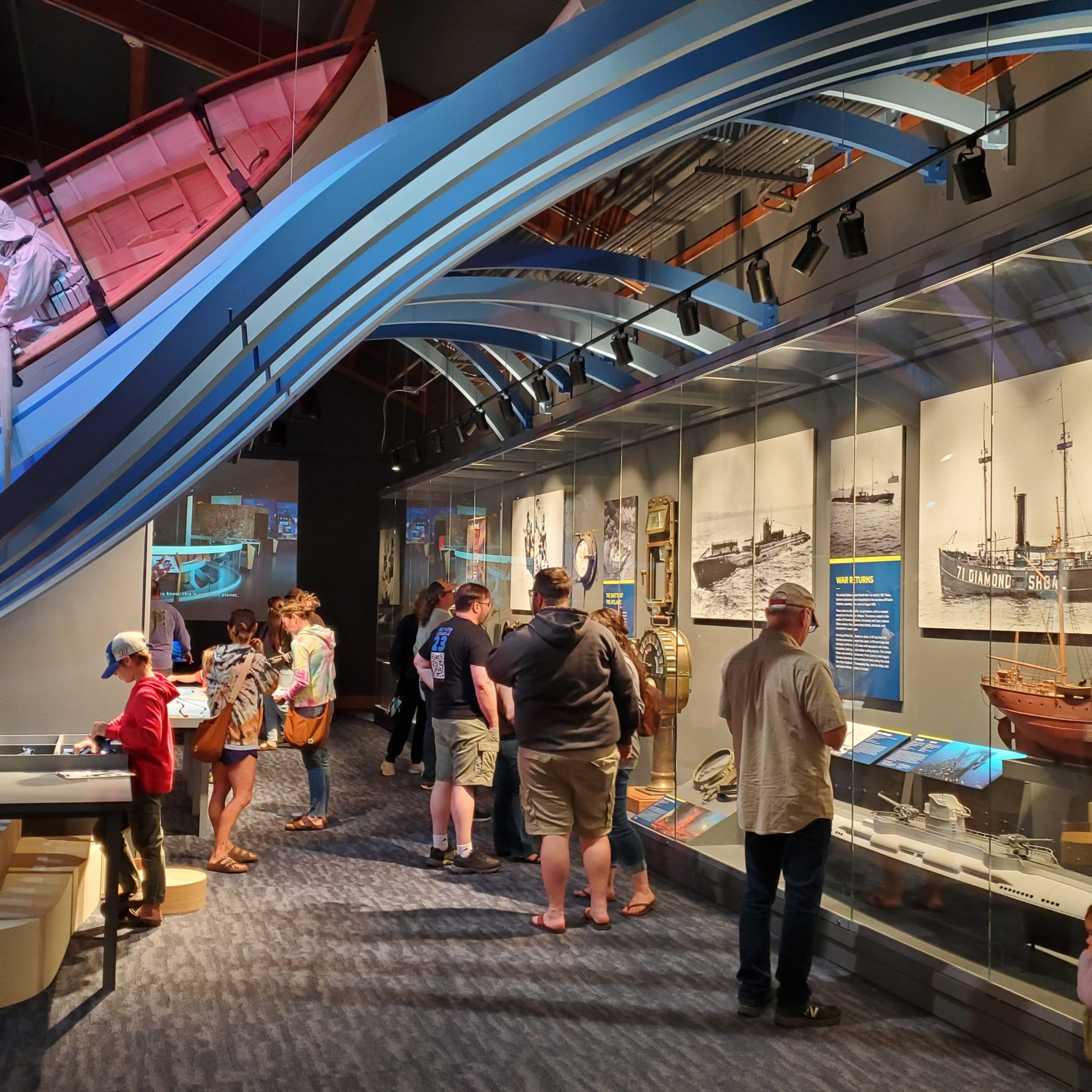 a crowd of people looking at different exhibits in the museum gallery