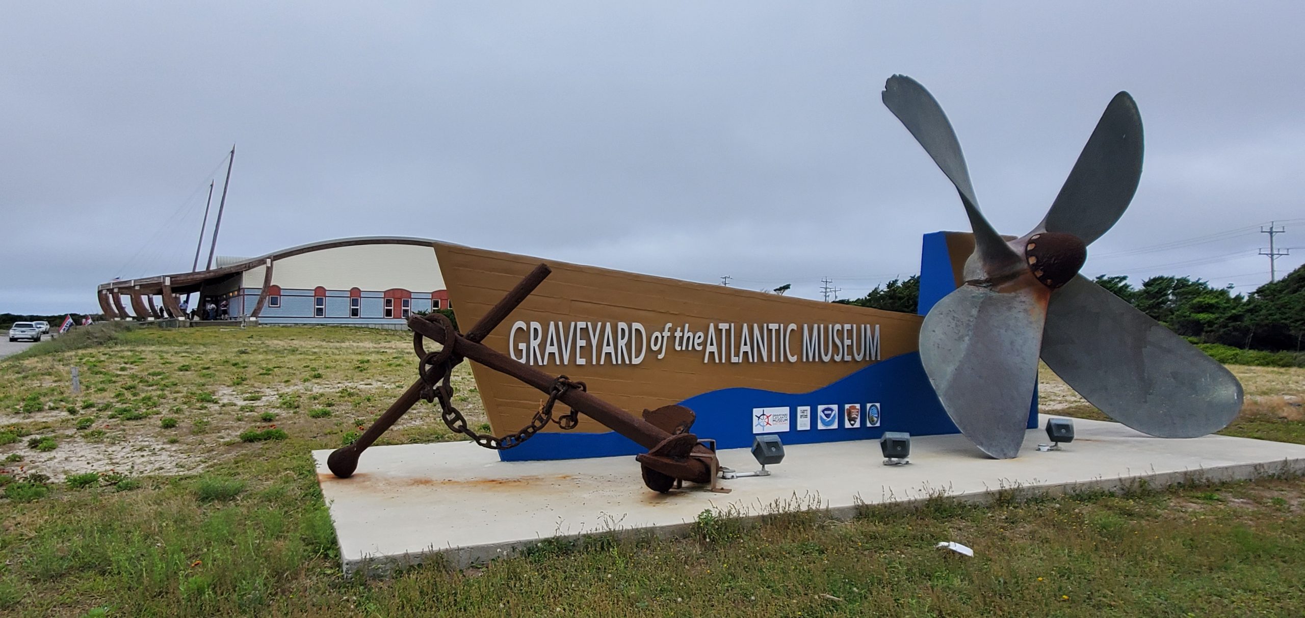 sign with museum's name outside the museum with a propeller and anchor